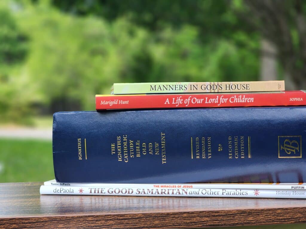 A stack of catholic homeschool books reviewed by the team.